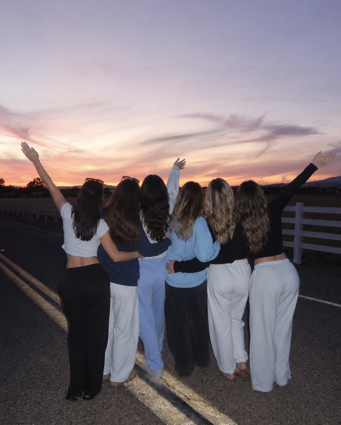 Friends waving at the sunset